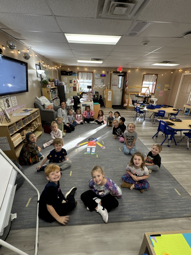 children smiling after completing building a person