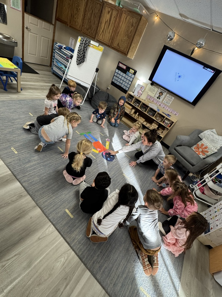 children watching and listening to teacher 