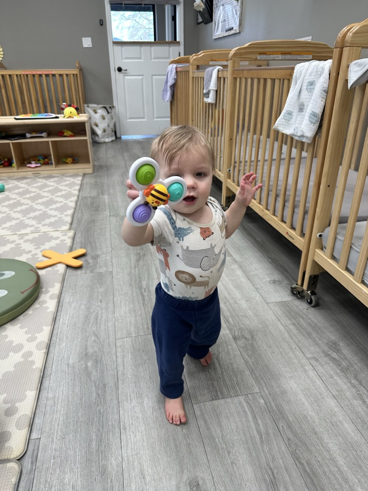 baby playing with pop it toy 