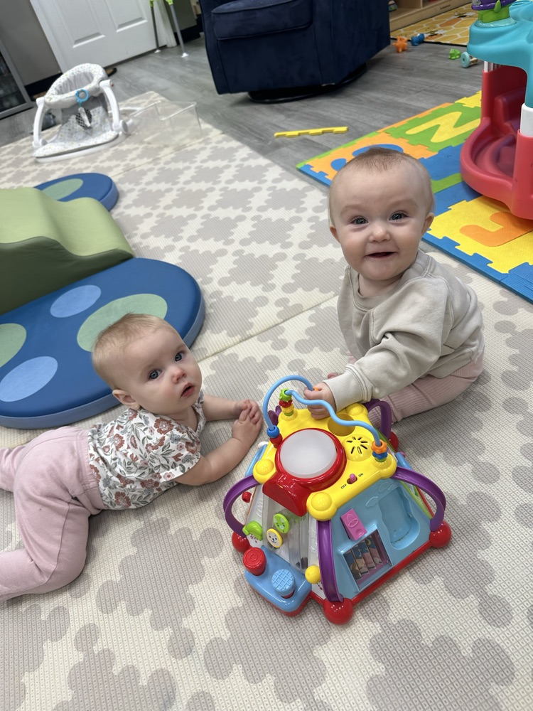 two babies in floor playing
