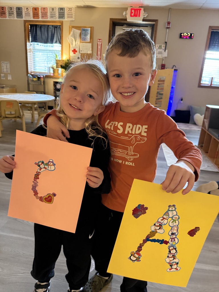 Children holding up letter art