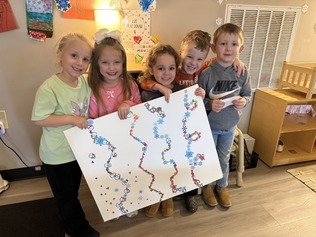 children holding up poster of stickers