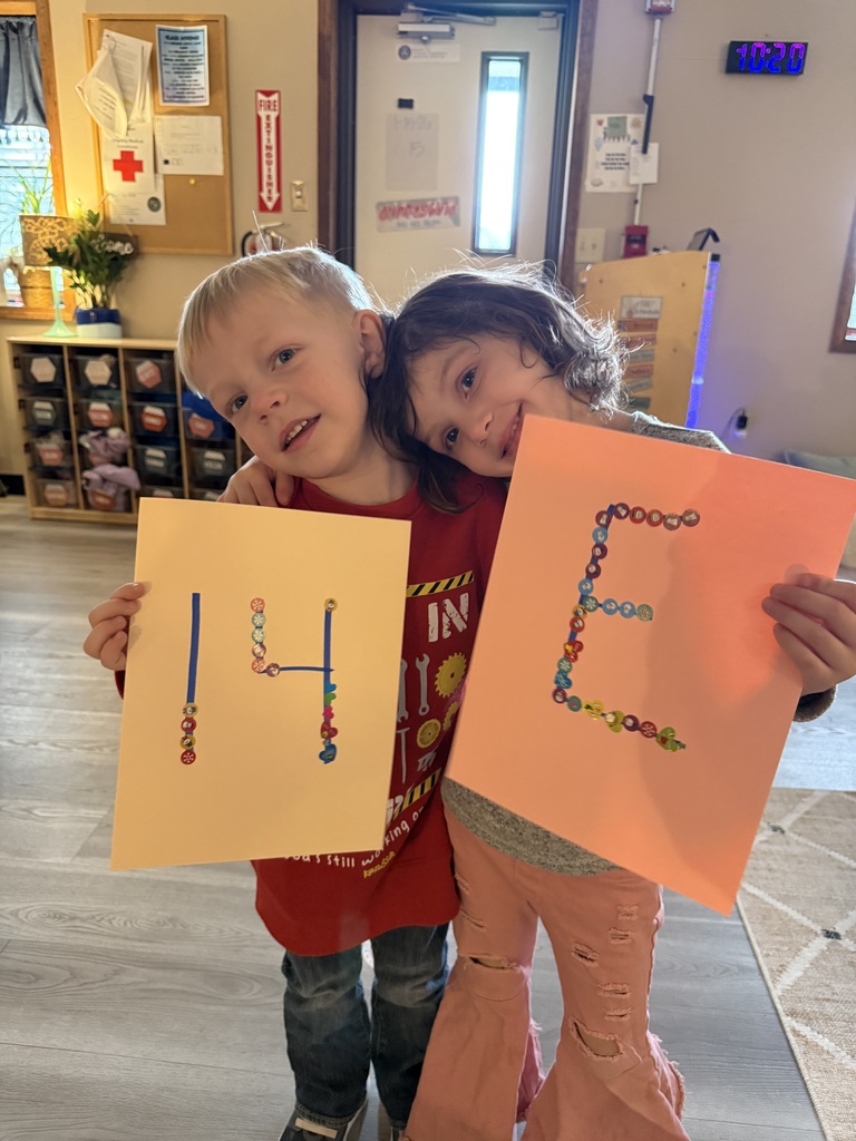 Children holding up letter and number art