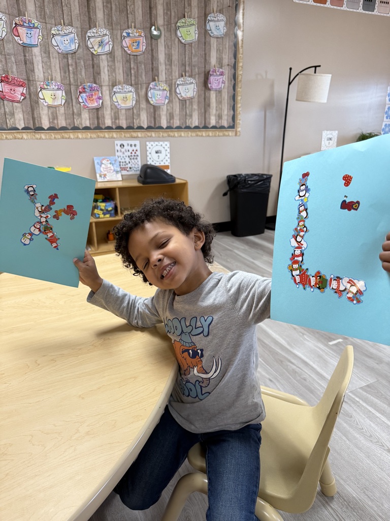 Child holding up letter art
