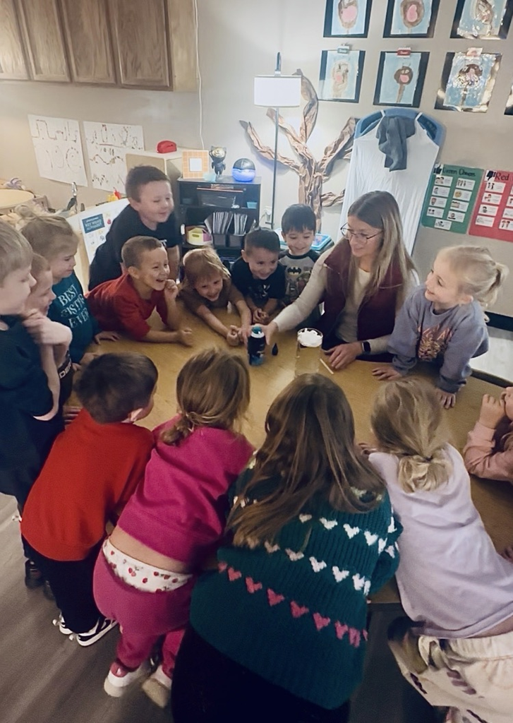 children observing a science experiment about rain