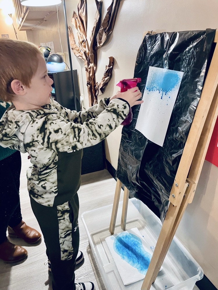 child doing rain art activity