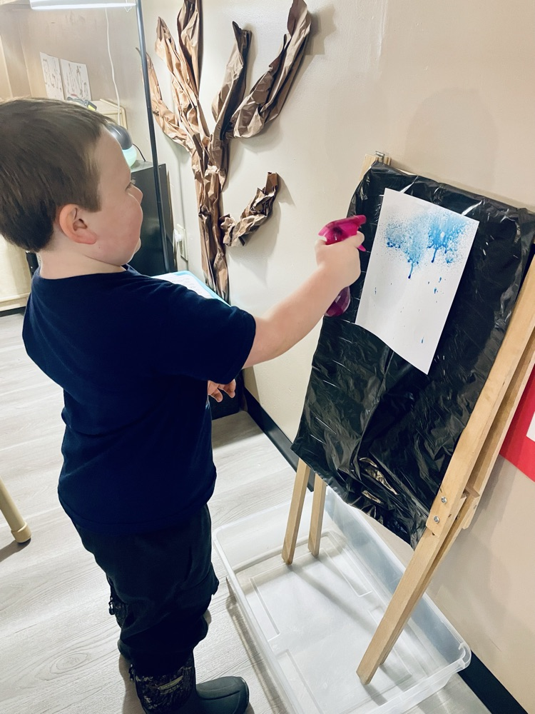 child doing rain art activity