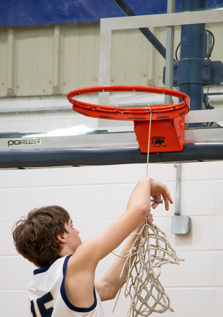 Boy cutting net down
