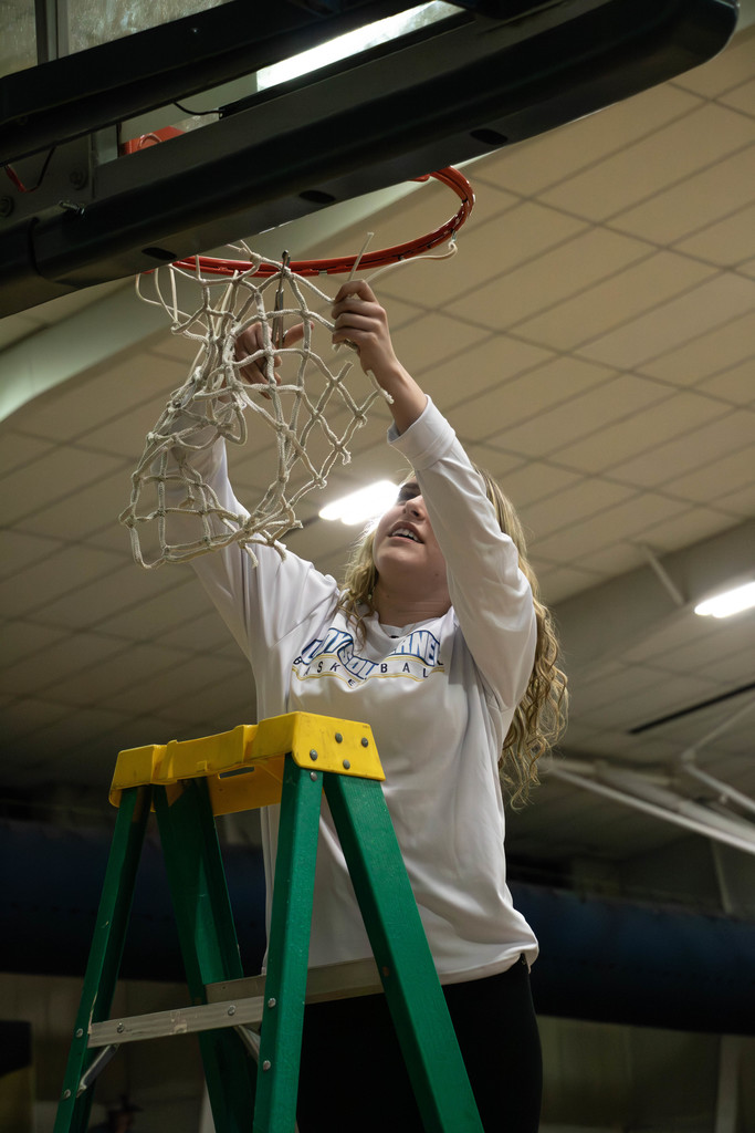 Girl cutting net down