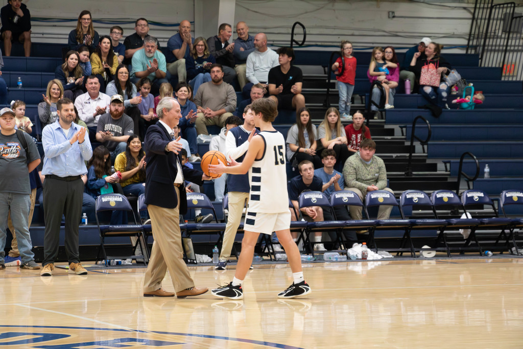 Coach giving boys game ball