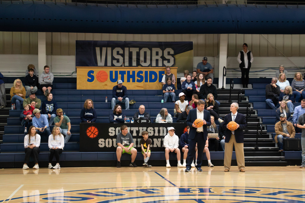 Head coaches holding game balls