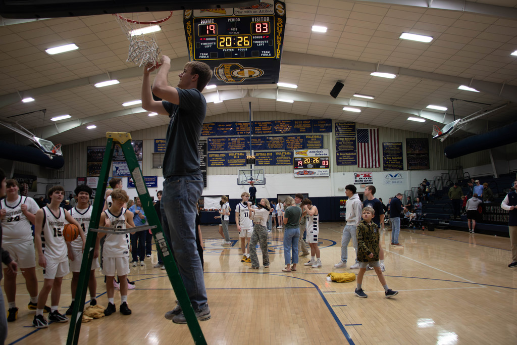 Boy cutting net down