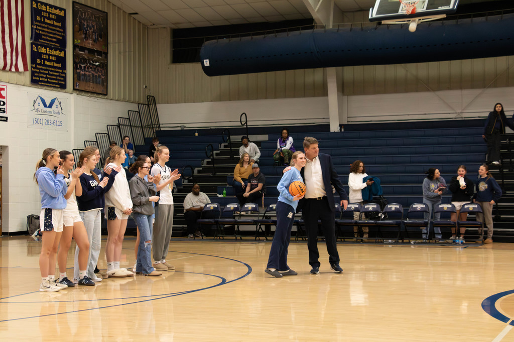 coach giving girls game ball