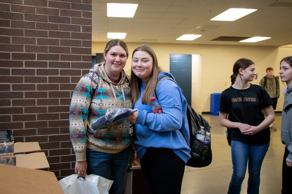 Two seniors with cap and gowns