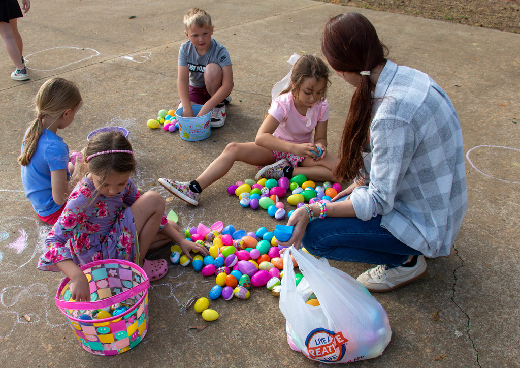 kindergarteners and teacher checking easter eggs