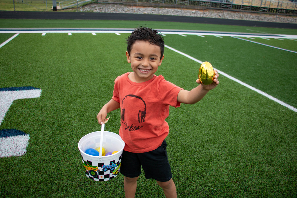 boy holding easter basket and gold egg