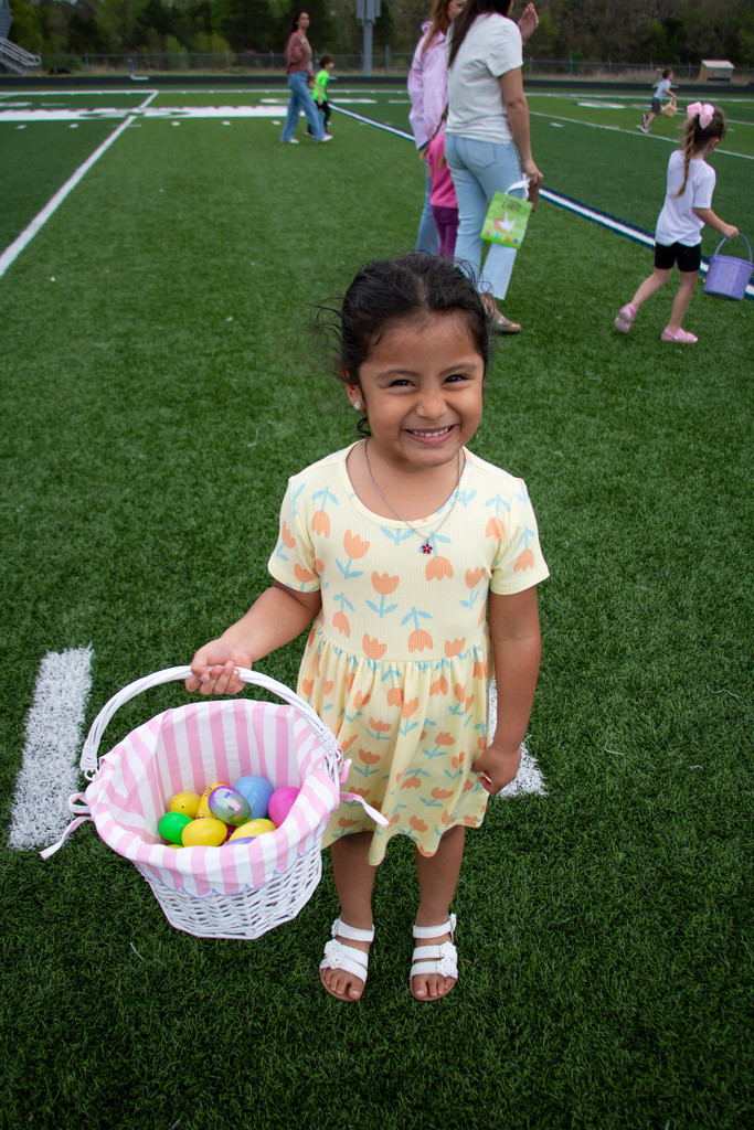 girl smiling holding easter basket with eggs