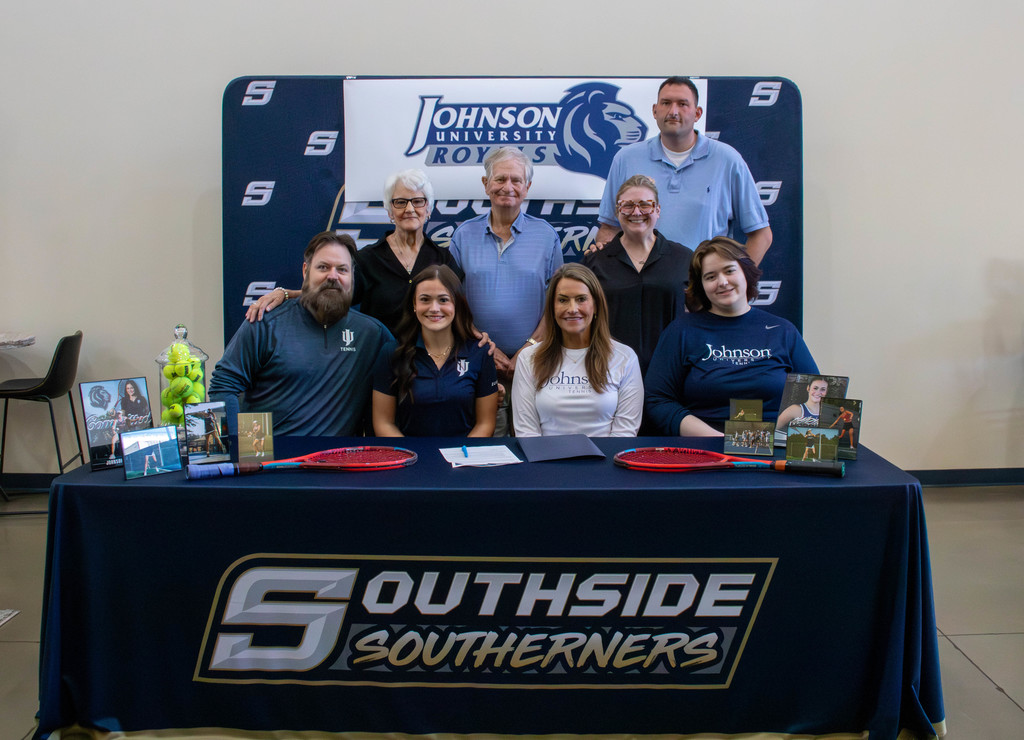 student and family at signing table