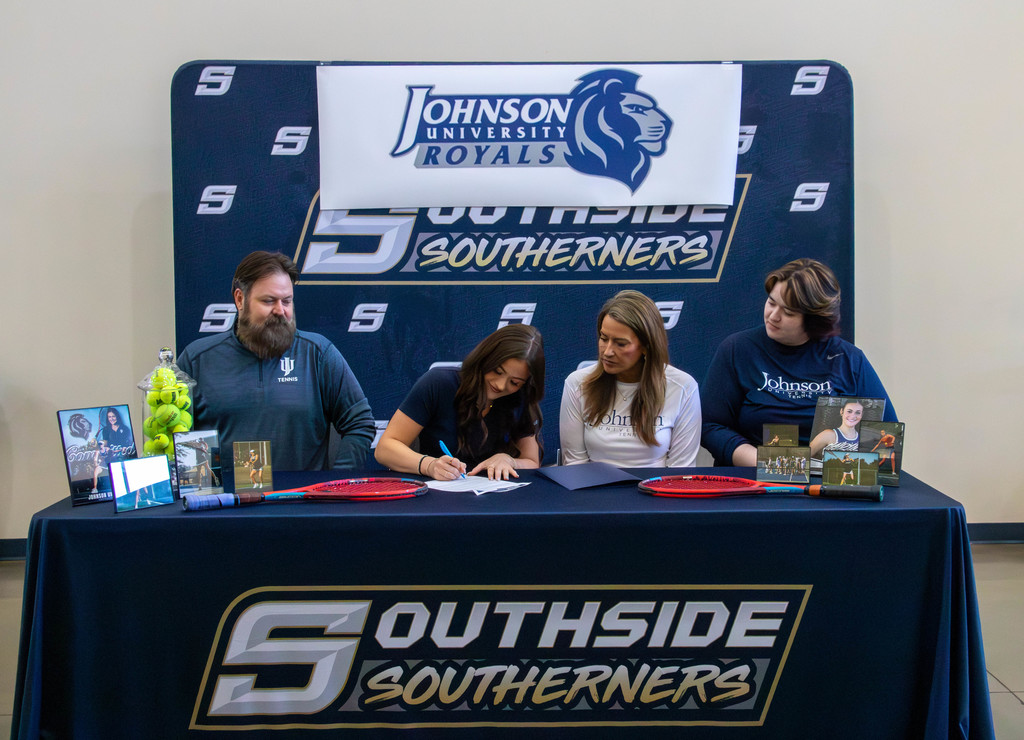 student signing and family watching