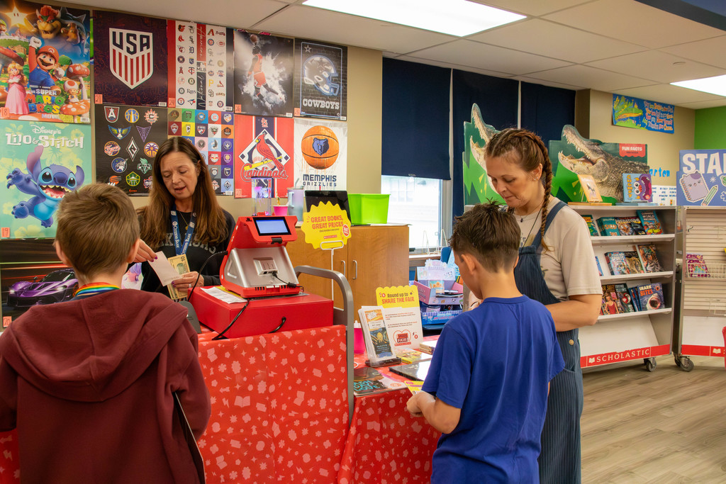 teachers and boys at book fair
