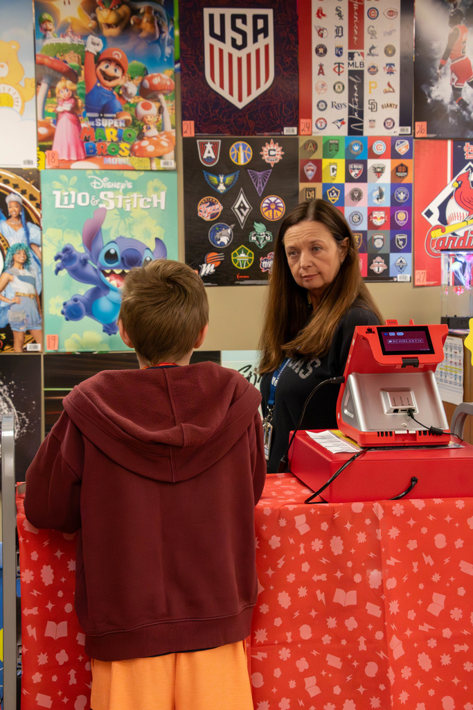 teacher and student at book fair register