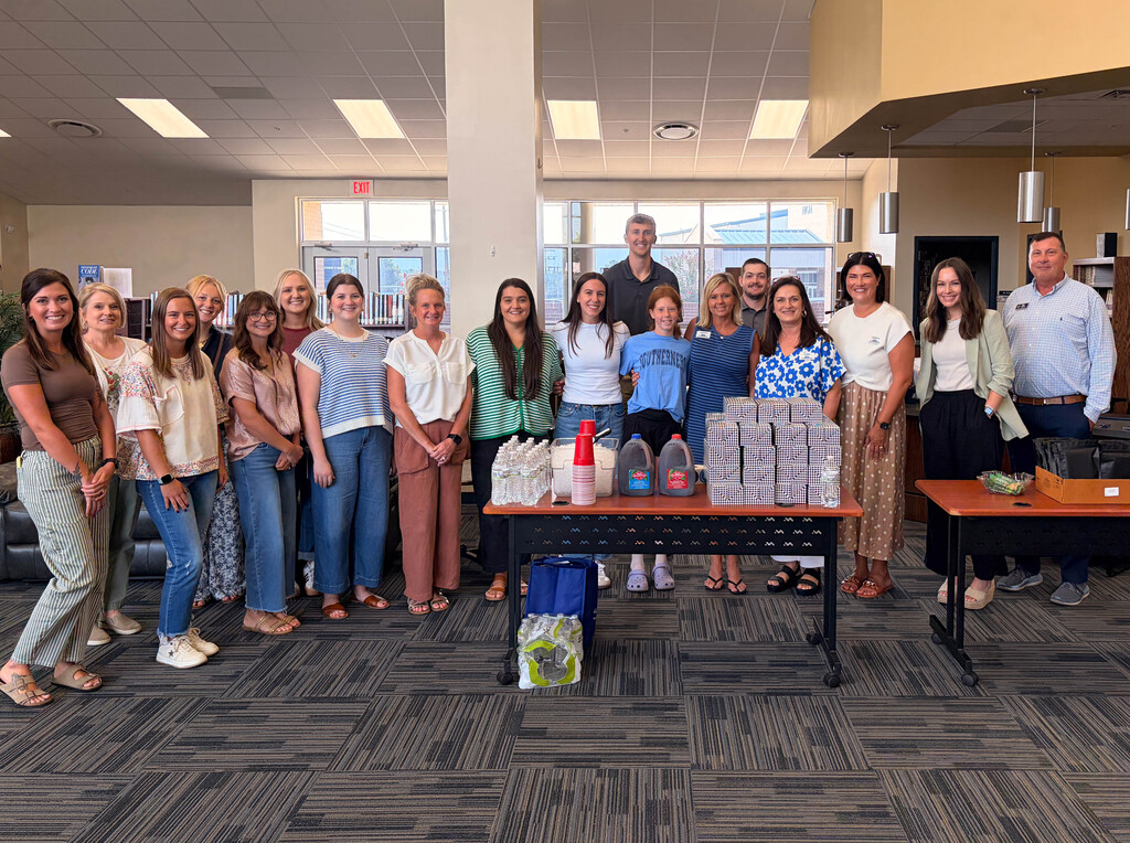 group of new teachers with lunches on a table