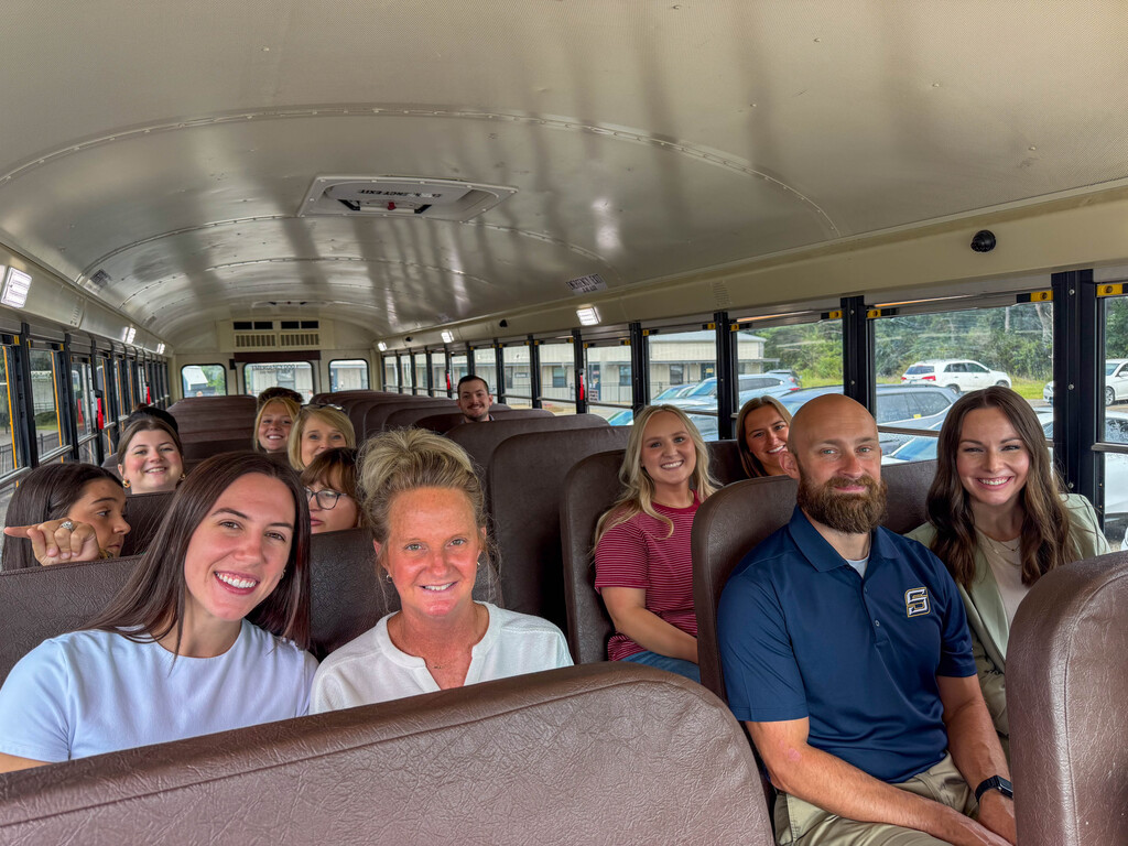 group of teachers on a school bus
