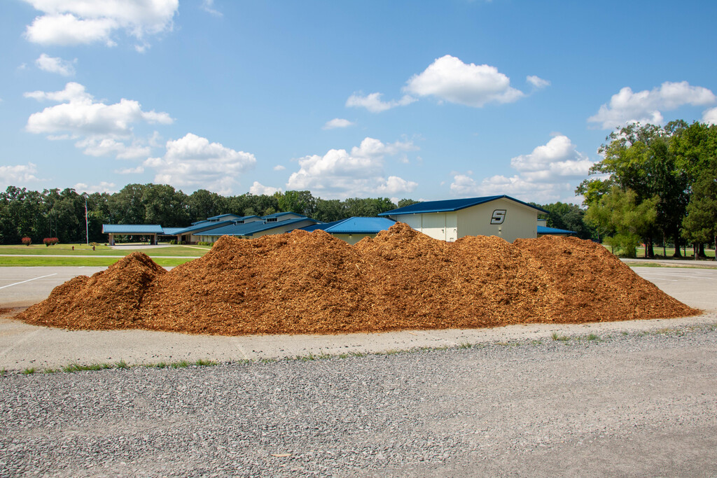 mulch with elementary school in the background
