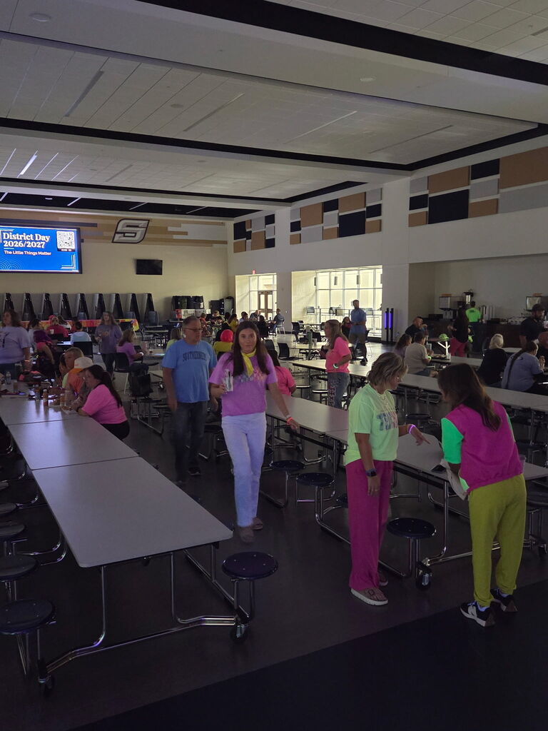 men and women gathered in a cafeteria