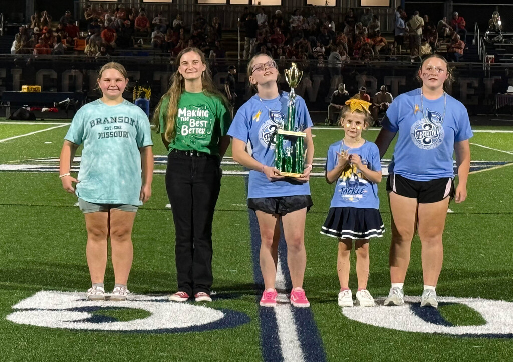 student holding trophy