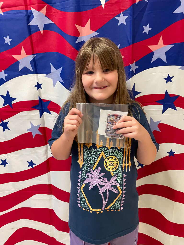 student holding baseball card