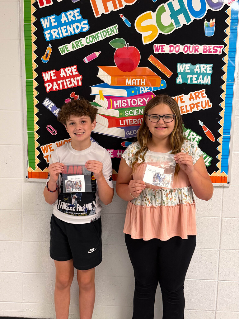 students holding baseball card