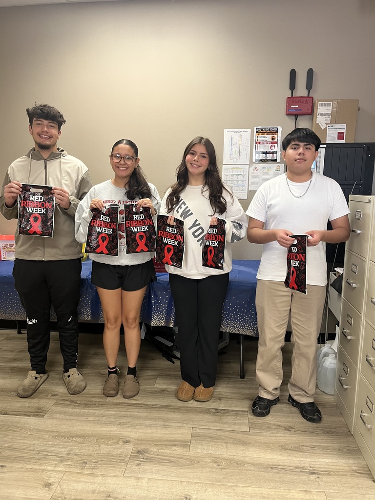students smiling holding goodie bags