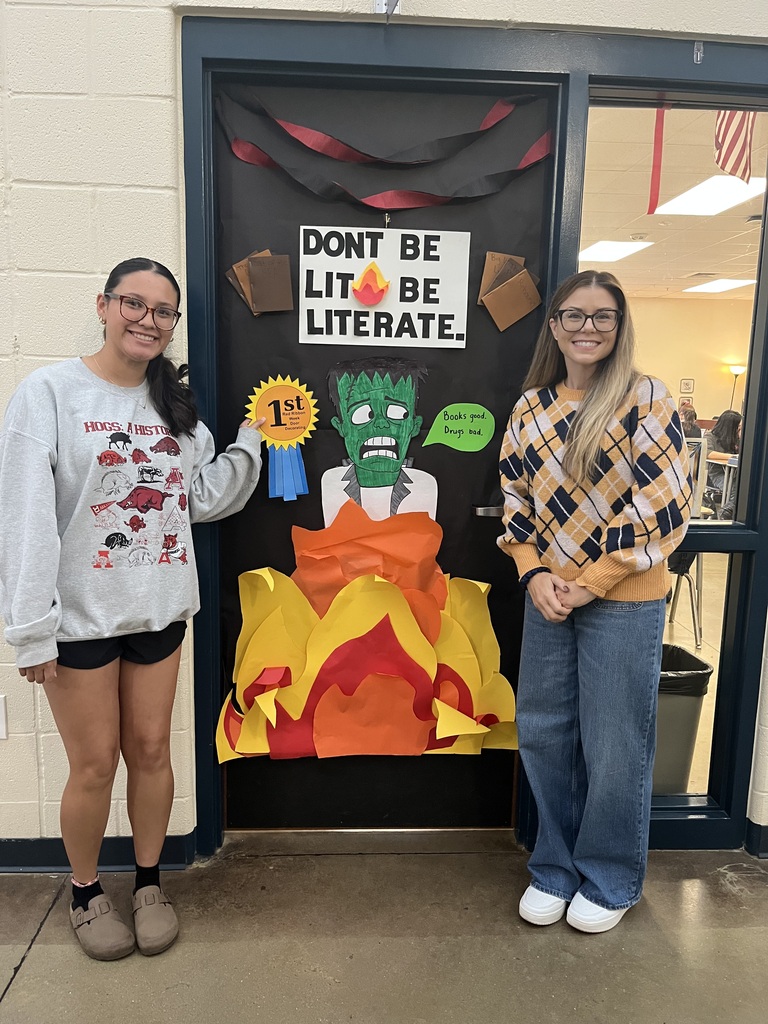 student and teacher smiling,  1st place door