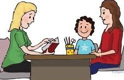 Teacher across a desk from mother and child, parent conference