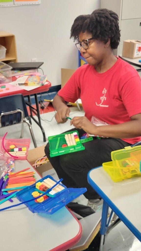 teacher making manipulative kit for reading