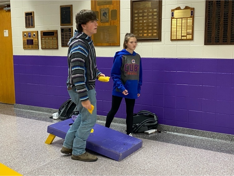 students playing corn hole