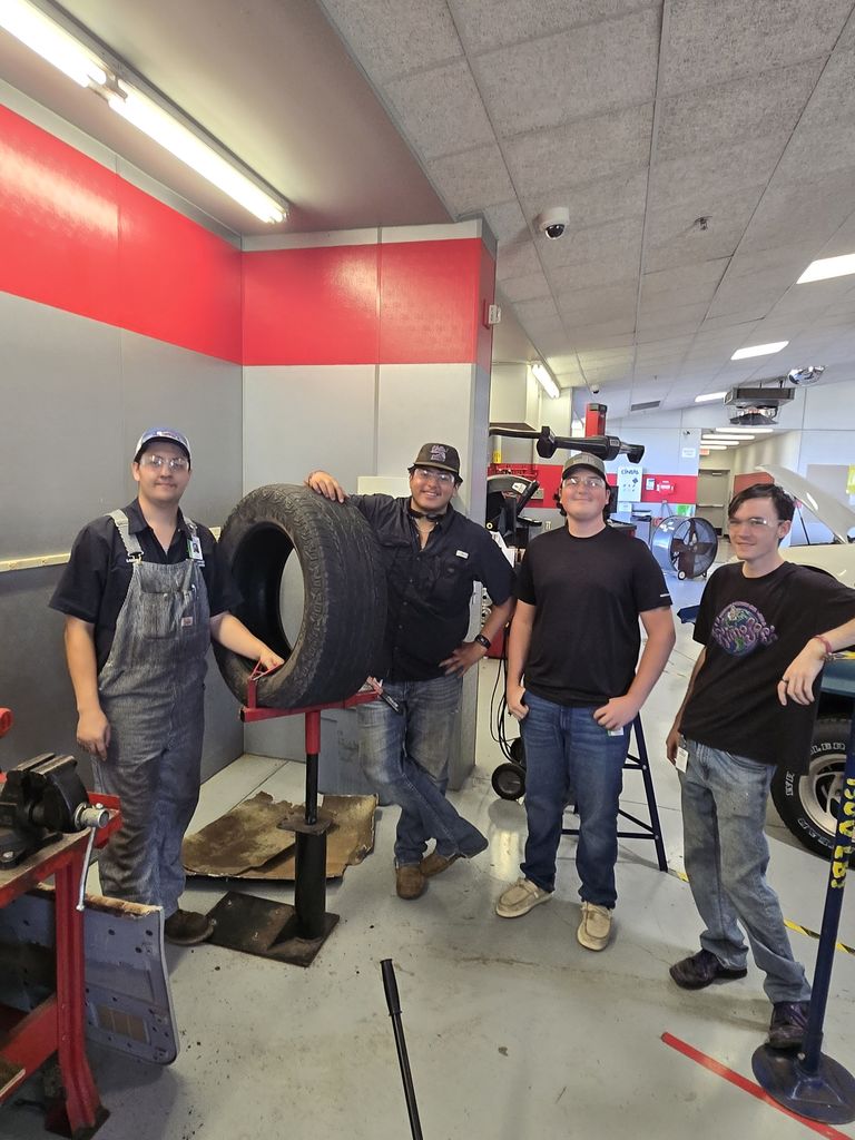 Auto students patching a tire