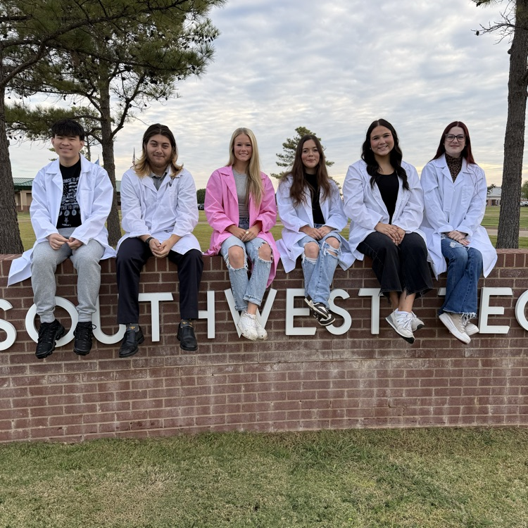 Group photo of teenagers in lab coats