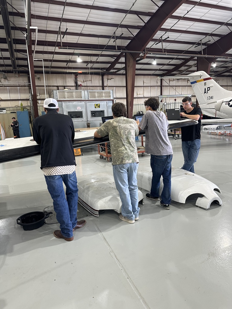 Students inspect a De-icer boot for a aircraft