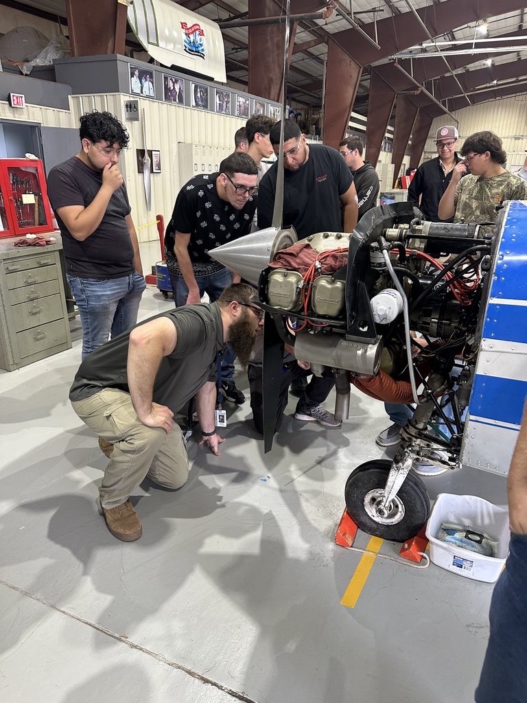 Instructor gives lesson about mufflers on a aircraft engine