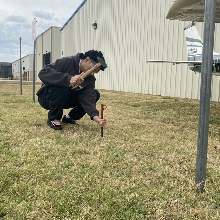 student staking in a tie down