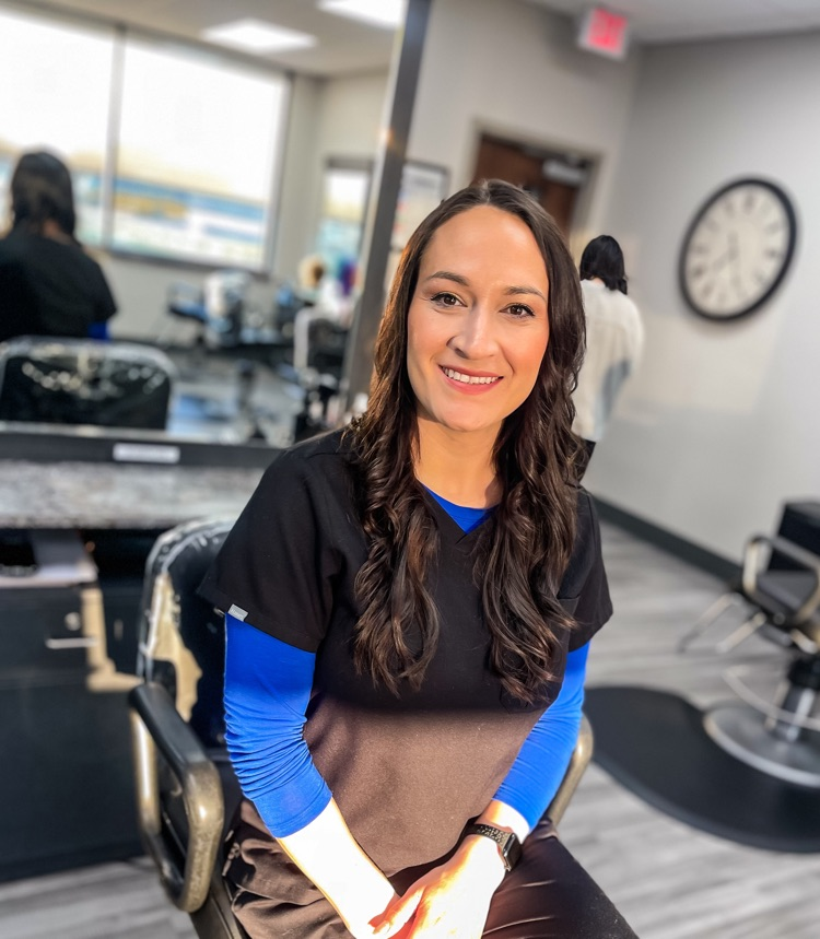 smiling woman sitttng in salon chair 