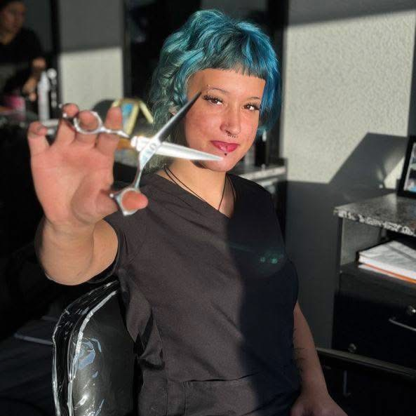 Woman posing with shears in hand 