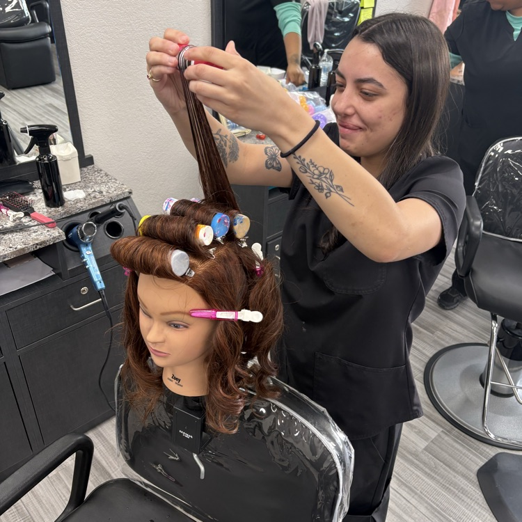 young woman working on perm using paint bottles