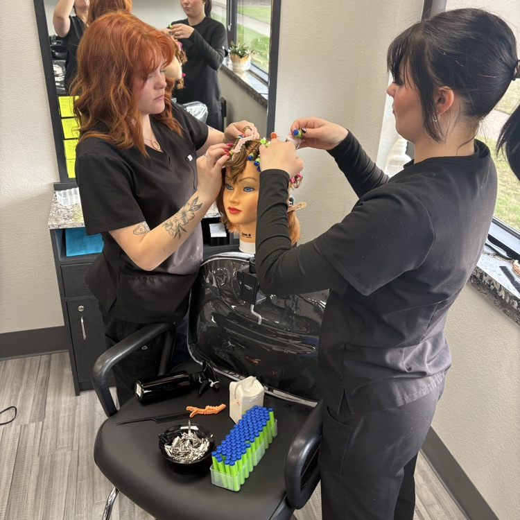 young women working on perm using nerf bullets