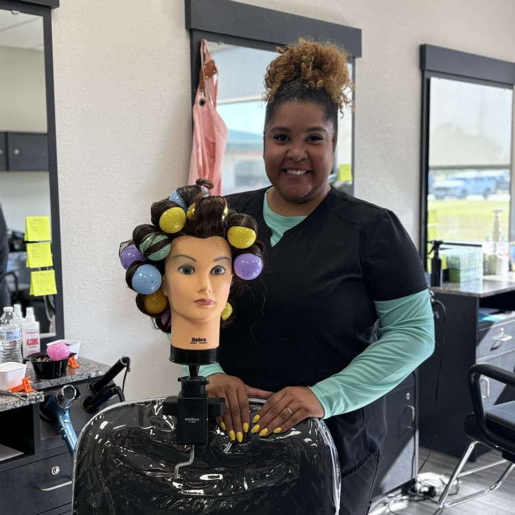 young woman standing next to head full of Easter eggs