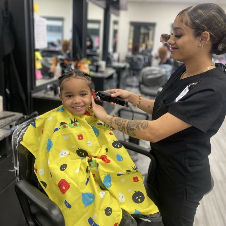 child getting hair cut
