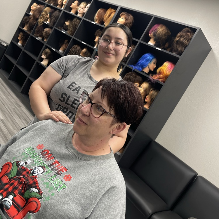 mother and daughter smiling at salon station