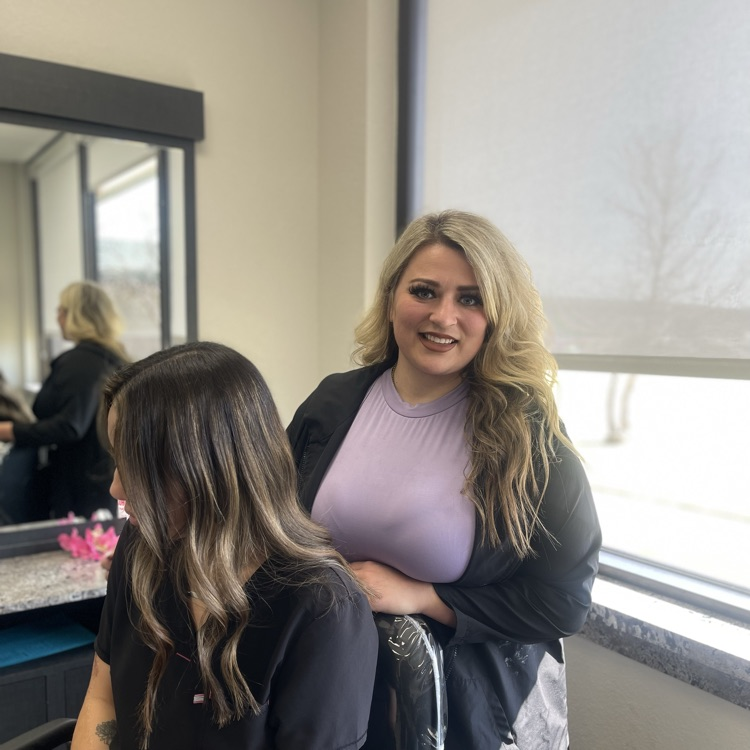 hair stylist displaying a balayage